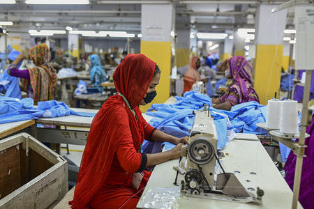 Labourers wearing face masks as a preventive measure work at a garment factory during the lockdown.
New Generation Fashion Limited workers resume on duty as factories reopen after the government eased the restrictions amid concerns over coronavirus disease (COVID-19) outbreak in Dhaka.