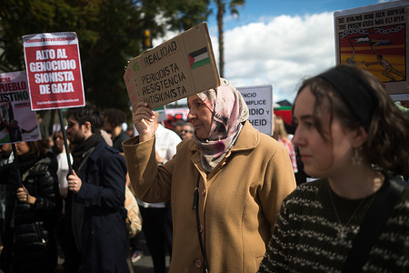 An elderly woman is seen holding a placard against Israel as she takes part in a demonstration in solidarity with Palestinian people. Under the slogan "Stop the genocide in Palestine", hundreds of people demand an end to the arms trade and trade relations with Israel, amid the ongoing conflicts between Israel and Hamas.