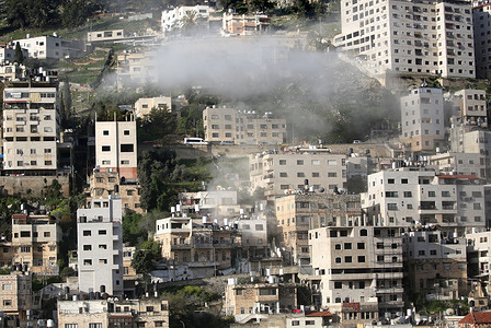Smoke rises from a Palestinian home after it was demolished with explosives by the Israeli army. Israeli forces demolished the home of Mahmoud al-Aqqad who is accused of carrying out a car-ramming attack that killed an Israeli soldier on September 28 2015 at an Israeli checkpoint.