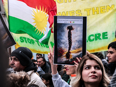 A woman holds a placard with a braid as Kurds and their supporters march in the centre of London to protest the inaction of the British government in the face of ISIS rise in Rojava, the autonomous Kurdish region of Syria. Kurds claim that ISIS, supported by Turkey, provides genocide against Kurdish population in Rajava. Kurds and their supporters march in the centre of London to protest the inaction of the British government in the face of ISIS rise in Rojava, the autonomous Kurdish region of Syria. Kurds claim that ISIS, supported by Turkey, provides genocide against Kurdish population in Rajava.
