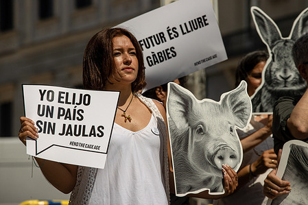 A pro-animal rights activist holds a placard during a demonstration. Members of several animal rights organizations gathered in front of the Congress of Deputies to demand an end to cages on farms in the European Union demanding that the European Commission fulfill "its commitment" to gradually ban this farming system.