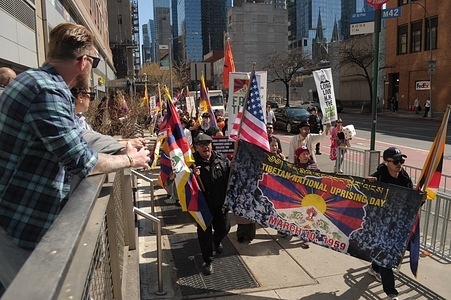 Pro-Tibet demonstrators march holding placards and a banner during the 67th Tibetan Uprising Day. Demonstrators rallied in Manhattan, New York City demanding Tibet's independence from China. The Tibetan Uprising Day marks the day in 1959 when thousands of Tibetans in Tibet surrounded the palace of the current and 14th Dalai Lama. The Dalai Lama is the spiritual Buddhist leader of Tibetans worldwide. The Tibetans surrounded the palace in 1959 to protect the Dalai Lama due to fears of a Chinese government plot to abduct him. On March 17, 1959, the Dalai Lama was forced to flee from Tibet to India to escape the threat of the Chinese government. Since 1959, the Dalai Lama has been living in exile in Dharamshala in northern India. The Chinese communist chairman, Mao Zedong, annexed Tibet in 1950 after a military invasion. Annually on Tibetan Uprising Day, demonstrators globally hold rallies demanding human rights and independence for Tibet, which has been under Chinese rule for more than 70 years.