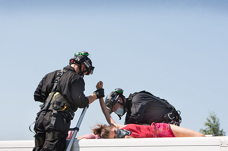 Specialist police officers release a protester that was tied to the top of a hire van during the protest outside the OSI Food Solutions factory in Scunthorpe.Over 50 Animal Rebellion protesters shut-down McDonald's only burger distribution plant, OSI Food Solutions factory in the UK by blockading the entrance with bamboo beacons and vehicles. The rebels demand McDonald's switch to totally plant-based menus by 2025 and put an end to the suffering of billions of lives and to avert the climate crisis while saving the Amazon Rainforest.
