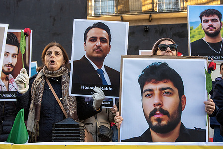 Protesters hold signs and chant slogans during the demonstration outside Downing Street in London. Around 50 members of the People's Mojahedin Organization of Iran gathered outside the Downing Street. (PMOI is an Iranian Islamist-Socialist militant opposition group.) Protesters want to show their support to the anti-government demonstrators in Iran. The members of the organization do not want to see the Shah or the Ayatollah in power and are calling for a democratic system.