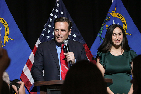 Nevada Republican Senate candidate Adam Laxalt speaks to supporters in Las Vegas on midterm election night, alongside him is his wife Jaime.