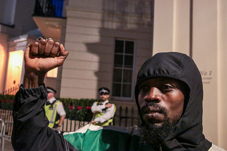 A man stands outside the Embassy of the United Arab Emirates in London, clenching his fist during the protest. Protesters accused the United Arab Emirates of funding Sudan’s Rapid Support Forces, a militia blamed for atrocities in the country’s civil war. As fighting devastates Sudan, demonstrators gathered outside the UAE Embassy in London demanded an end to foreign interference and accountability for those fueling the conflict.