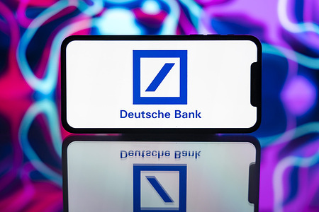 In this photo illustration, the Deutsche Bank logo is seen displayed on a mobile phone screen.
