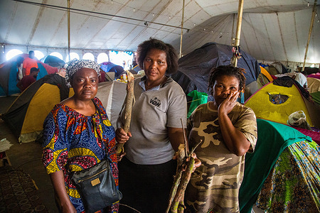 Women pose for a photo inside a refugee camp in Cape Town after being relocated.
Due to xenophobic violence, many foreign nationals have been relocated to camps in Kensington and Bellville by the city of Cape Town as the Covid-19 pandemic gripped the country.