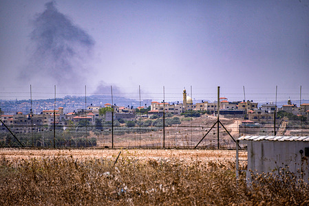 A cloud of smoke in the sky following the airstrike by the Israel Defense Forces is seen at the border of the Palestinian camp in the city of Jenin. Israel Defense Forces raid a Palestinian camp near the city of Jenin, north of the occupied West Bank. They started the raid with an air strike followed by a ground assault of more than 100 armored vehicles, which killed 9 Palestinians and seriously injured dozens.