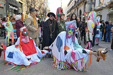 People dressed in traditional costumes seen during the Masquerade festival, a celebration of ancestral rituals rooted in northern Spain, on Arenal Street in Madrid.