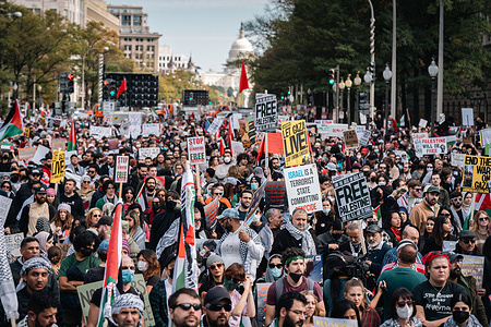 Protesters gather in front of the White House while holding signs and flags during the pro-Palestinian demonstration. The protesters are calling for an immediate ceasefire in Gaza, where thousands have been killed by Israeli airstrikes since the October 7 Hamas terror attacks.