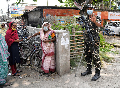 A member of the Central Security Force looks on while standing on guard during the 2021 West Bengal Legislative Assembly election in Baruipur.