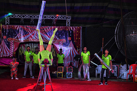 A female artist performs a reverse stunt during the special show of Razdhani Circus. Circus reopens for audiences after being closed for almost three years due to financial strain & lack of public interest. Circus in India is gradually becoming a dying industry due to the indifferent attitude of the Government, lack of interest by the audience along with complete restrictions on Animal shows.