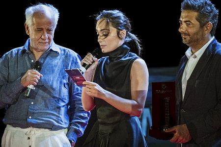 Actress Denise Capezza, Tony Servillo and Gianvito Casadonte, organizer of the festival attend the first Author Conversation moderated by Fabrizio Corallo during the Magna Graecia Film Festival at the Lungomare Arena.