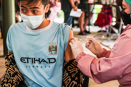 A health worker administers a dose of the Moderna Covid-19 vaccine to a tourist in Dusun Bambu.
The West Bandung Regency Government collaborating with tourism managers held a mass COVID-19 vaccination in Lembang Tourism area to attract public interest in vaccinations.