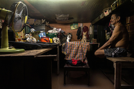 A man and his cats seen sits on the table in his flooded house.
Thailand has faced flash flood due to the heavy rainfall, tidal bore, and water drainage from Chao Phraya Dam after Dianmu Storm hit the country. Many residents face floods every year but this year the water level instantly rose and caused more damage than usual.