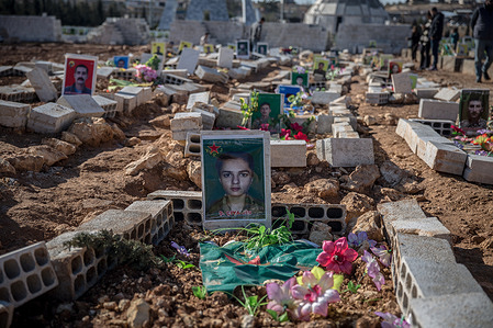 A recent grave at the Martyrs’ Cemetery in Kobane, where graves of Women's Defense Units (YPJ) and People's Defense Units (YPG) fighters, and members of the Asayish internal security forces killed in fighting with government forces in January, are visible beside older graves of those killed fighting ISIS. The Kurdish-led Syrian Democratic Forces (SDF) lost huge swathes of territory in January, leaving the northern Syrian city isolated.