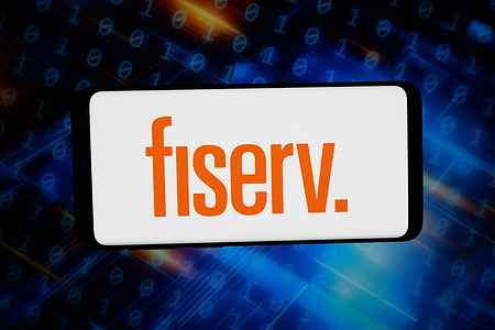 In this photo illustration, the logo of US fintech company Fiserv Inc. is displayed on a smartphone in front of abstract background on computer screen.