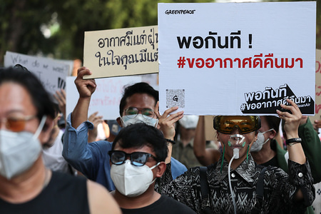 Protesters wear dust masks while holding placards during the rally.
Environmental activists rally to demand rights to clean air, near the Thai Government House in Bangkok, Thailand, as the country struggles to contain worsening air pollution.