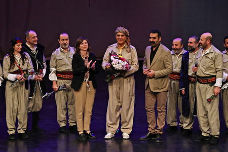 After the play "The Epic of Morasin", Diyarbakir Metropolitan Municipality Co-Mayors Serra Bucak (L) and Dogan Hatun are seen congratulating the play's author and director, Dr. Ghotbedin Sadeghi, by giving her flowers. The Kurdish play “The Epic of Morasin” (also spelled Moraşîn) premiered on the opening day of the 11th International Amed Theater Festival in Diyarbakir, Turkey, organized by the Diyarbakir Metropolitan Municipality. Written and directed by Iranian-Kurdish playwright Dr. Ghotbedin Sadeghi, the production tells the story of two lovers separated by poverty and war.