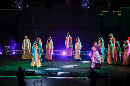 Palestinians perform during a ceremony ahead of the lighting of a Christmas tree at Manger Square outside the Church of the Nativity, in Bethlehem in West bank.