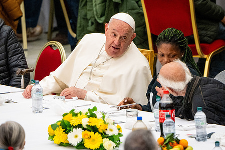 Pope Francis greets and speaks with some of the poor and homeless who attended the lunch in the Paul VI Hall. On World Day of the Poor, Pope Francis invited the poor and homeless to Mass and a common meal with 1300 people at the Paul VI Hall in Vatican City.