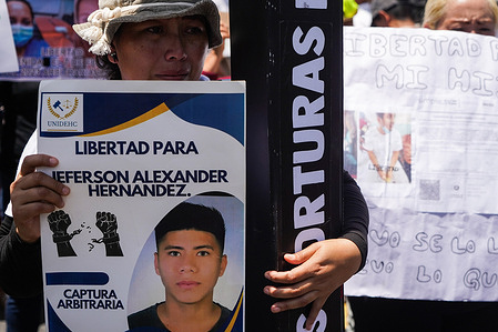 A protester from the Movement of Victims of the State of Emergency (MOVIR) holds a poster during a demonstration demanding the Supreme Court of Justice declare the State of Emergency Unconstitutional in San Salvador. Protesters are calling on El Salvador’s Supreme Court to declare the state of emergency unconstitutional. They argue that its repeated extensions since March 2022 have stripped citizens of rights like due process and freedom of association, violating both the Constitution and international law. The government, however, insists the measure is vital for public safety and dismisses critics as sympathetic to gangs.