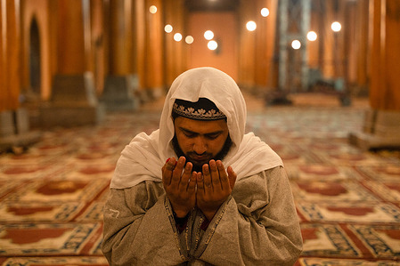 A Kashmiri Muslim man prays before performing the first Tarawih prayers to mark the start of the holy month of Ramadan at the Jamia Masjid, also known as the Grand Mosque, in Downtown Srinagar. Ramadan is the ninth month of the Islamic lunar calendar, during which Muslims worldwide fast from dawn to sunset, refraining from food, drink and marital intimacy as a form of spiritual reflection, prayer and charity. Muslims believe the Quran was first revealed to the Prophet Muhammad during this month.