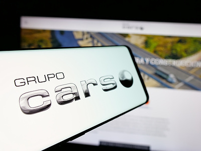 In this photo illustration, a smartphone with the logo of Mexican company Grupo Carso S.A.B. de C.V. is seen on screen in front of business website.