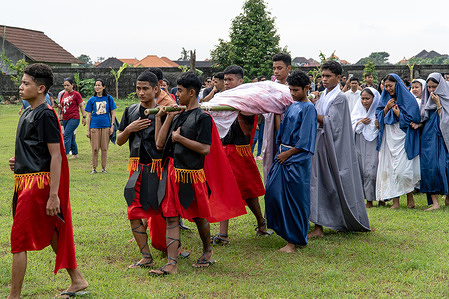 The body of Jesus of Nazareth is carried to the tomb after being taken down from the cross, depicting the moment following the crucifixion. Students of St. Thomas Aquino Catholic High School perform a Passion Play depicting the crucifixion of Jesus Christ at the Seminary of the Holy Spirit in Tuka. The theatrical tableau is part of a series of religious observances held during the Holy Week to commemorate Good Friday, marking the death of Jesus Christ ahead of Easter Sunday.
