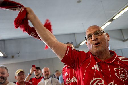 A Nottingham Forest supporter raises a scarf while fans gather in Porto ahead of the UEFA fixture against FC Porto Nottingham Forest 1 - 1 FC Porto