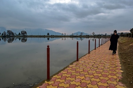 A man seen walking along the banks of Dal lake during a cloudy day in Srinagar, Kashmir.
The Kashmir Valley would remain mostly cloudy on Sunday, with scattered rain and thunder-showers across the state for the next 24 hours, a local Meteorological Department forecast said.