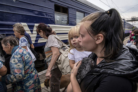 A mother holds her daughter boarding the evacuation train at Pokorvsk Train Station, Donetsk. Amid intensified fighting in the Eastern part of Ukraine, east Ukraine is now accelerating its civilian evacuation. Many people are being relocated to the western part of the country. According to the United Nations, at least 12 million people have fled their homes since Russia's invasion of Ukraine, while seven million people are displaced inside the country.