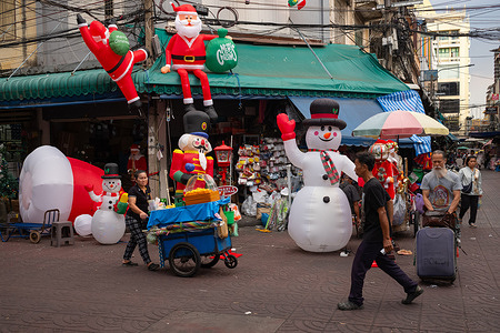 Giant inflatable Santa Claus decorations are seen in front of a decorations shop in ChinaTown, Bangkok.