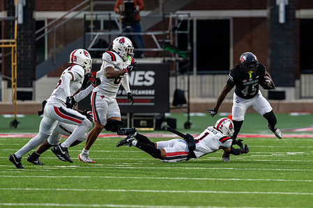 Northern Illinois Huskies RB Telly Johnson Jr. (45) and Ball State Cardinals DB Joedrick Lewis (1) in action during the Northern Illinois Huskies vs Ball State Cardinals game at Huskie Stadium. Final Score: Northern Illinois Huskies 21:7 Ball State Cardinals