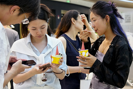 People seen eating ice cream in a shopping mall as the city experiences high temperatures.