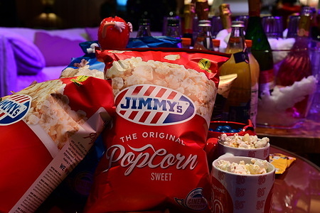 A bag of popcorn seen on a table in front of a movie theater at the Alpe d'Huez ski resort.