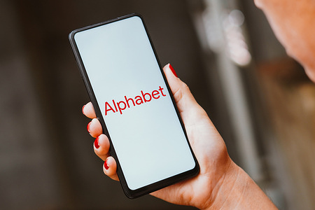 In this photo illustration, the Alphabet Inc. logo is displayed on a smartphone screen.
