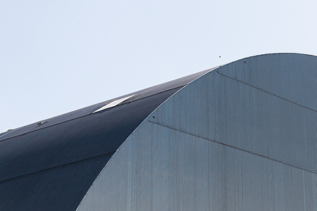 A protective shell above the destroyed Unit 4 is seen covering radioactive debris and structural elements. A new 2 megawatt solar power plant has been commissioned at the Chornobyl Nuclear Power Plant to provide power for the station's critical infrastructure, including the New Safe Confinement and spent nuclear fuel storage facilities. The solar panels were provided by the government of Lithuania with the support of the United Nations Development Programme and Japan, and the generation itself covers about 5% of the industrial site's annual consumption. Such on-site generation makes the ChNPP more resilient and less dependent on external power supply, and is one of the necessary conditions for nuclear and radiation safety. Inside the protective shelter over the destroyed fourth power unit are the remains of the reactor, fuel-containing masses, radioactive debris, and structures.