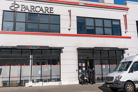 Customer talks to security guard at the ParCare Health and Medical Center Williamsburg office in Brooklyn Borough of New York City. Dr. Howard A. Zucker, Commissioner of Health for New York State, said in a statement Saturday that Parcare Community Health Network in Orange County is being investigated for allegedly fraudulently obtaining and distributing a COVID-19 vaccine to members of the public in violation of state guidelines.
