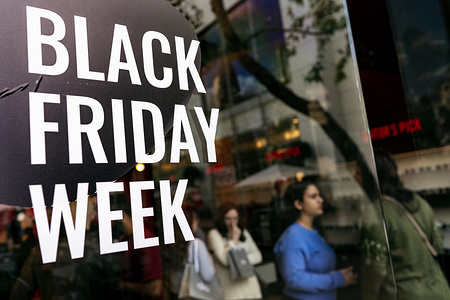 LOS ANGELES, UNITED STATES, NOVEMBER 29, 2019:
Shoppers walk past a Black Friday sign in Los Angeles.
Black Friday occurs the day after Thanksgiving and that marks the beginning of the holiday shopping season, as retailers lure shoppers with reduced prices.