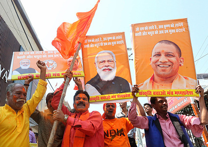 Bharatiya Janata Party and Sanskriti Bachao Manch activists hold posters of Prime Minister Narendra Modi and Chief Minister of Uttar Pradesh Yogi Adityanath as they celebrate the lead of BJP in Uttar Pradesh, Manipur, Goa and Uttarakhand State Assembly elections. Votes are counted in five States after the Assembly elections, out of which BJP is leading in four States except in Punjab.