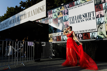 A woman seen posing in front of a van with a tour poster for Taylor Swift's Eras Tour outside the National Stadium before the start of the first concert in Poland. American singer Taylor Swift will play three concerts in Warsaw, Poland on August 1, 2, and 3 as part of her Eras Tour at the National Stadium (PGE Stadion Narodowy). Thousands of people from Poland and other countries will attend the concert. However, some fans, known as Swifties, who did not secure tickets gathered around the stadium to hear the star.