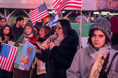 Activist speaks as Iranian diaspora and supports gather with The Lion and Sun flag historic Iranian national flags, American flags and Israeli flags during a demonstration for regime change in Iran after the U.S. and Israel attack Iran in "Operation Epic Fury" at Times Square on March 2, 2026 in New York City.