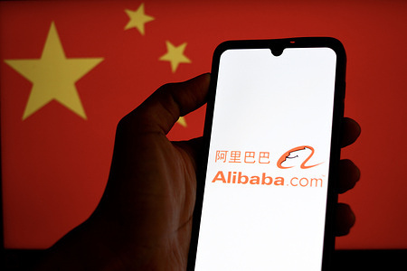 In this photo illustration, an Alibaba logo is displayed on a mobile phone screen with the flag of China in the background.