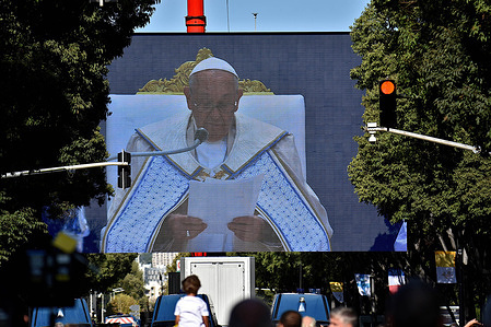 People attend the mass given by Pope Francis at the Vélodrome on a super giant screen. Thousands of people came to see Pope Francis stroll in his “Papamobile” on Avenue du Prado, they attended the high mass on giant screens at the Vélodrome stadium.