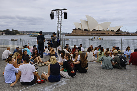 Friends and family are seen waiting for the Australia Day fireworks at Circular Quay Harbour Lookout. People gather at the Circular Quay Harbour Lookout while waiting for the Australia Day fireworks, as crowds build along Sydney Harbour ahead of the evening celebrations.