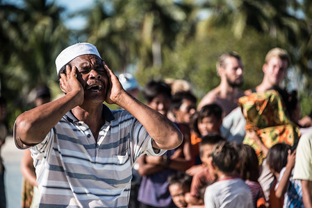 An Imam chants during a water festival held annually by the inhabitants of kalapuan Island. The festival is a purification ritual aimed at absolving transgressions and tends more toward ancestral tradition than Islam, which was introduced more recently.