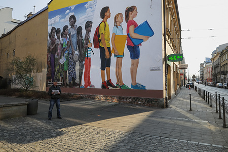 A man stands on an empty street next to a graffiti during the corona virus pandemic.
Polish Government has introduced a state of epidemiological emergency and closed borders. Most public places like schools, universities, restaurants, etc. have been closed to prevent the spread of coronavirus.