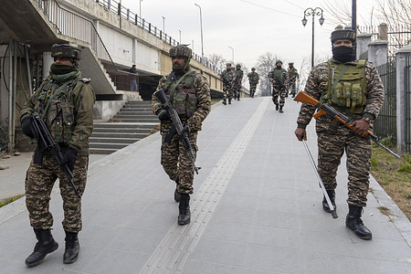 Indian security force personnel patrol a street during what officials described as a routine search operation in Srinagar, the main city of Indian administered Kashmir.